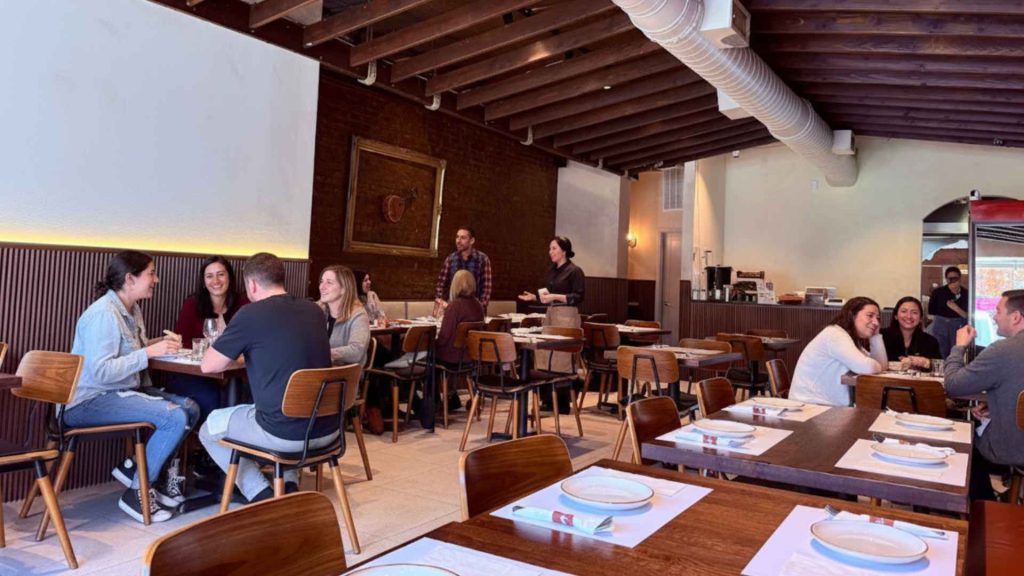 Guests dining inside Yemenat NYC’s warm, family-friendly dining room in Bay Ridge Brooklyn.
