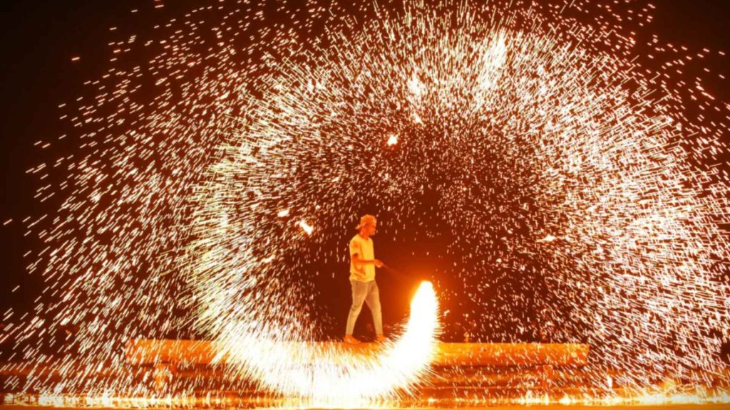 Burning Crab Festival 2026 beach crowd at night