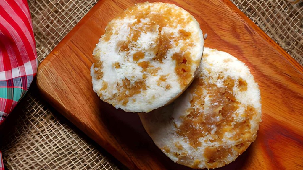 Dhaka street foods in winter favorite bhapa pitha made with rice flour, jaggery, and coconut wrapped in banana leaves