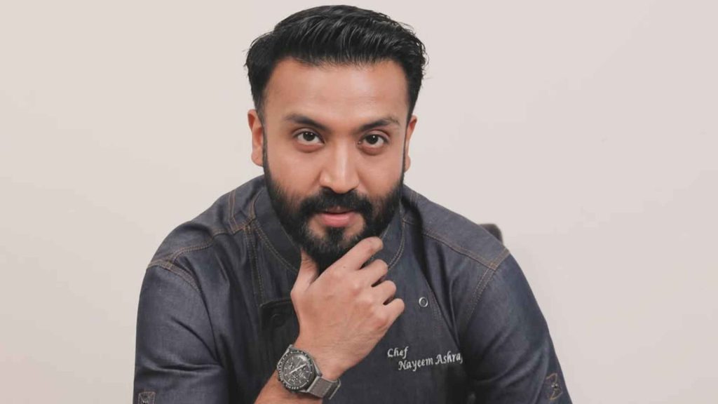 Nayeem Ashraf plating a dish in the kitchen, symbolizing the connection between food and culture.