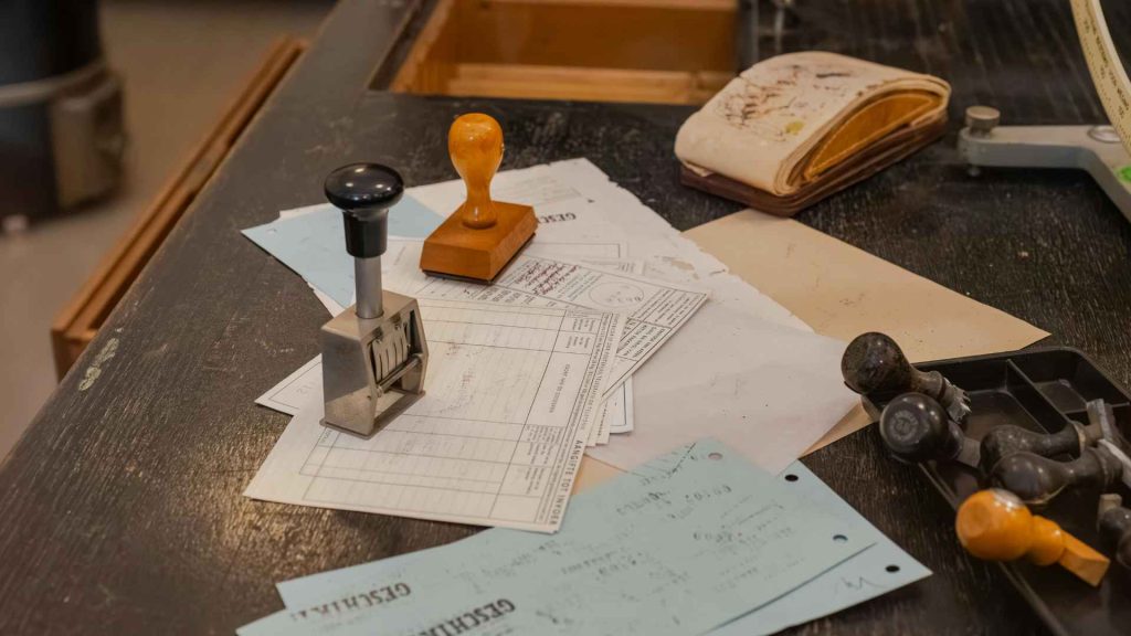 Rubber stamps and official paperwork on a desk symbolizing the physical marking and verification process for postal ballots Bangladesh election