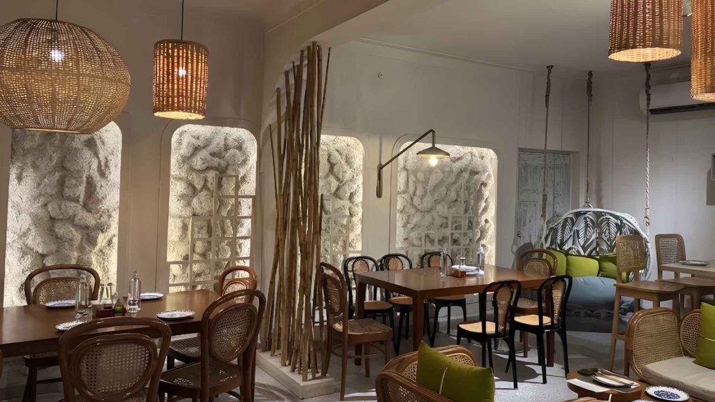 The cozy, boho-chic interior ambiance with warm lighting and rattan furniture at Dessert Boutique, home to the best dessert in Banani.