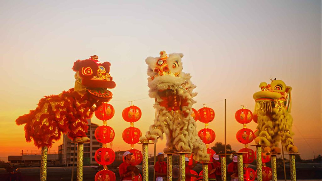 Heritage Above the Horizon: The Breathtaking Art of High-Pole Lion Dancing during the Brooklyn Lunar New Year Parade celebrations at sunset.