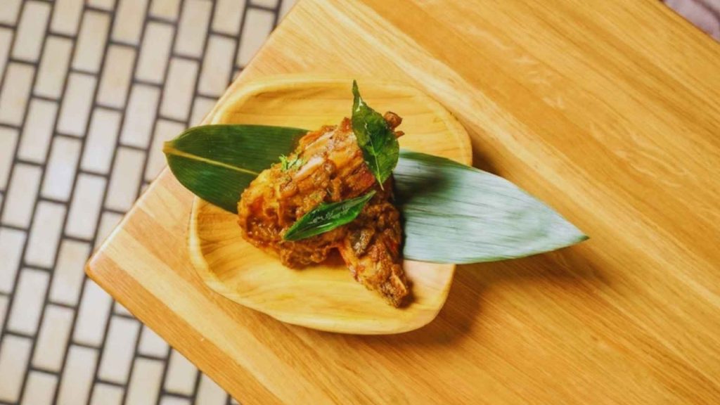Coastal prawn dish served on a banana leaf, highlighting the diversity of South Indian cuisine in NYC at Semma.