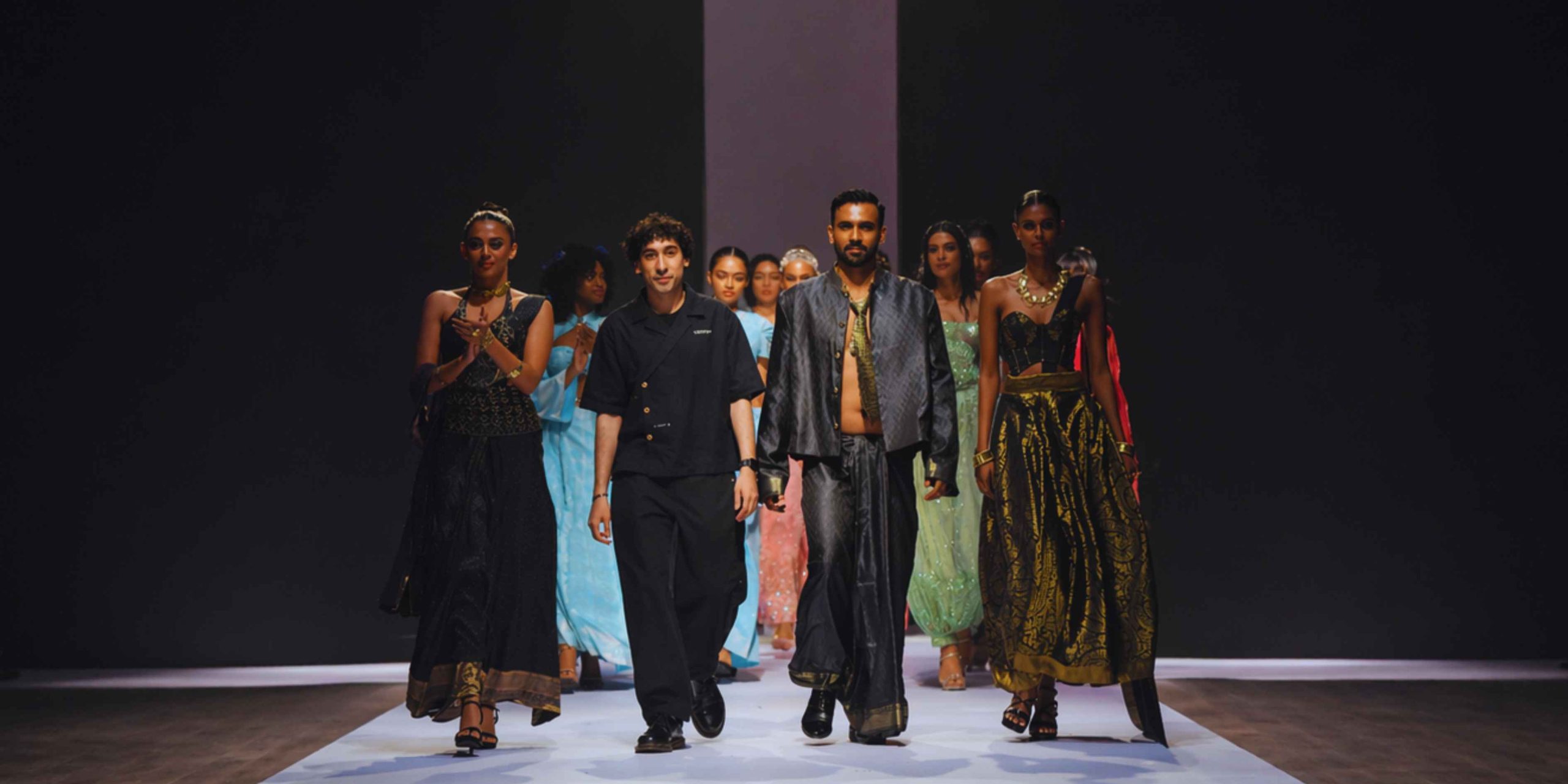 Asad Sattar Ami Dhaka Colombo Fashion Week grand finale walk featuring a dark structural collection with models and the creative director.